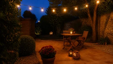 Terrasse de jardin le soir : guirlande chaude et lampions solaires groupés près de la table